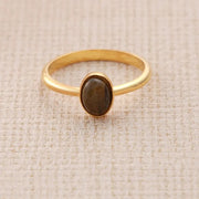 14k Gold filled ring with a brown Tiger's Eye stone on a beige fabric background