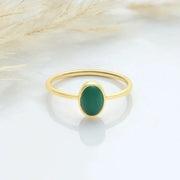 14k Gold filled ring with a green oval stone on a white background.