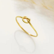 14k Gold filled knot-shaped ring on a light background
