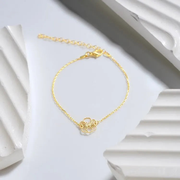 14k Gold filled birth flower cut-out bracelet on a white background