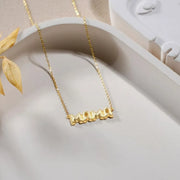 14k Gold filled bubble name necklace with 'MAMA' pendant on a neutral background