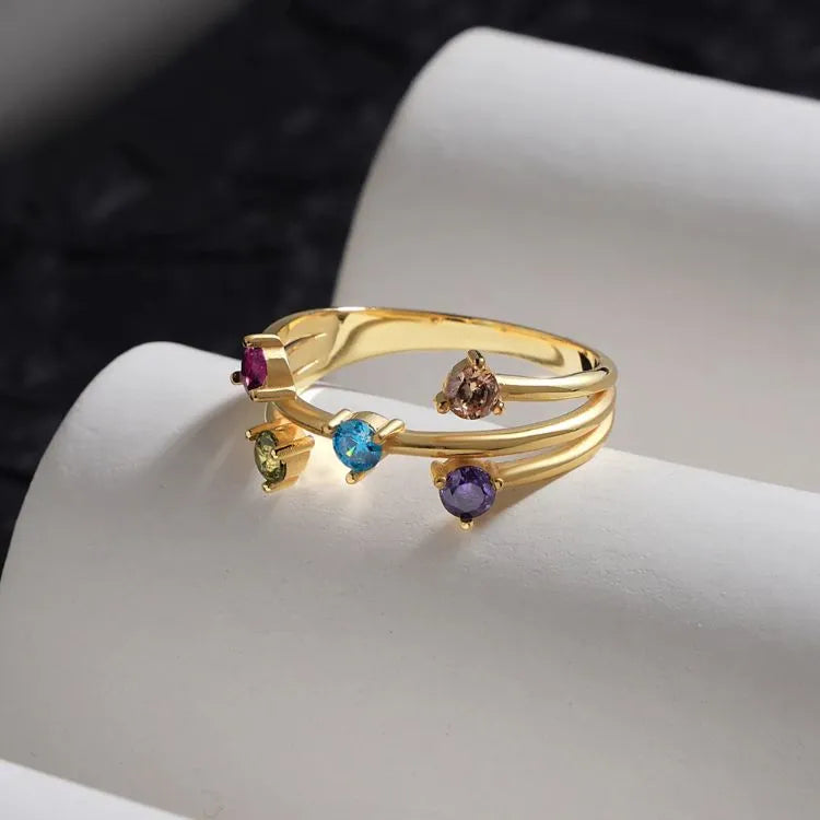 14k Gold filled ring with colorful gemstones on a white surface