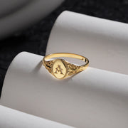 14k gold filled oval signet ring with initial A engraving and filigree detailing.