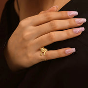 14k Gold filled pub ring on a woman model's finger against a dark background
