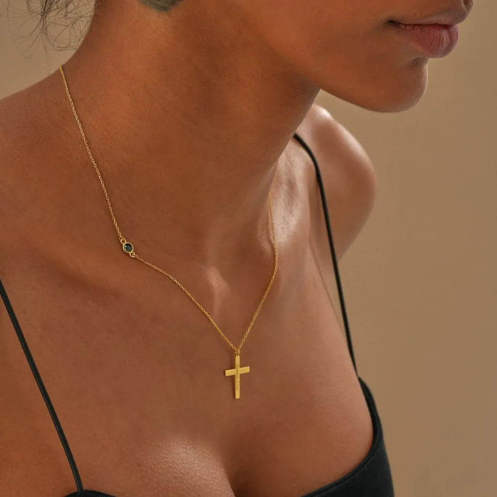 Woman model is wearing custom cross necklace with gemstone