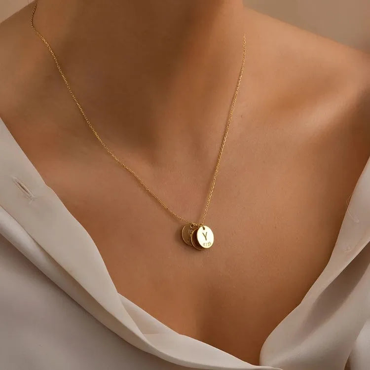 14k Gold filled necklace with a circle disc pendant on a woman wearing a white blouse.