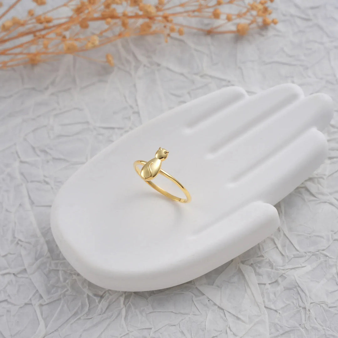 14k Gold filled cat ring on a white hand-shaped jewelry stand with dried flowers in the background