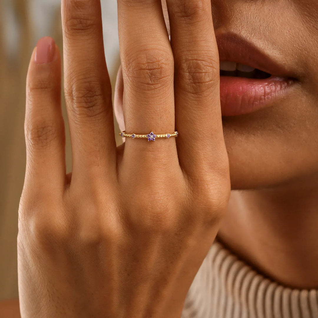 Model is wearing a tiny flower birthstone band ring model
