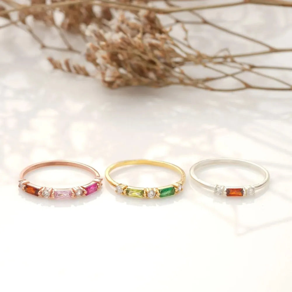 Three rings with colorful gemstones on a soft white background.
Colors/materials:
925 Sterling Silver – durable and high-quality, marked as 925
14k Gold Filled – thick layer of solid gold bonded to sterling silver, tarnish-resistant
14k Rose Gold Filled – warm rose hue with lasting shine, crafted to resist tarnish