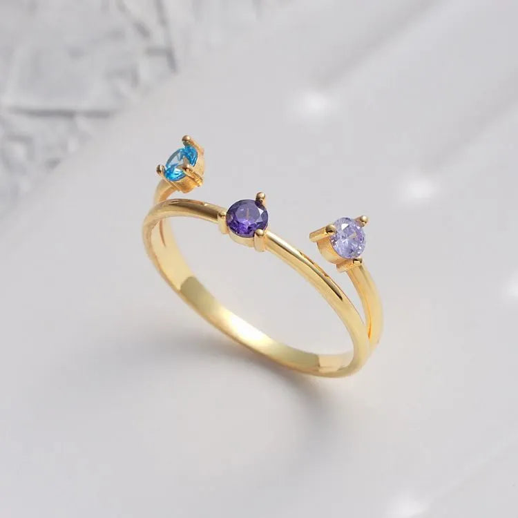 14k Gold filled ring with three gemstones on a light gray background