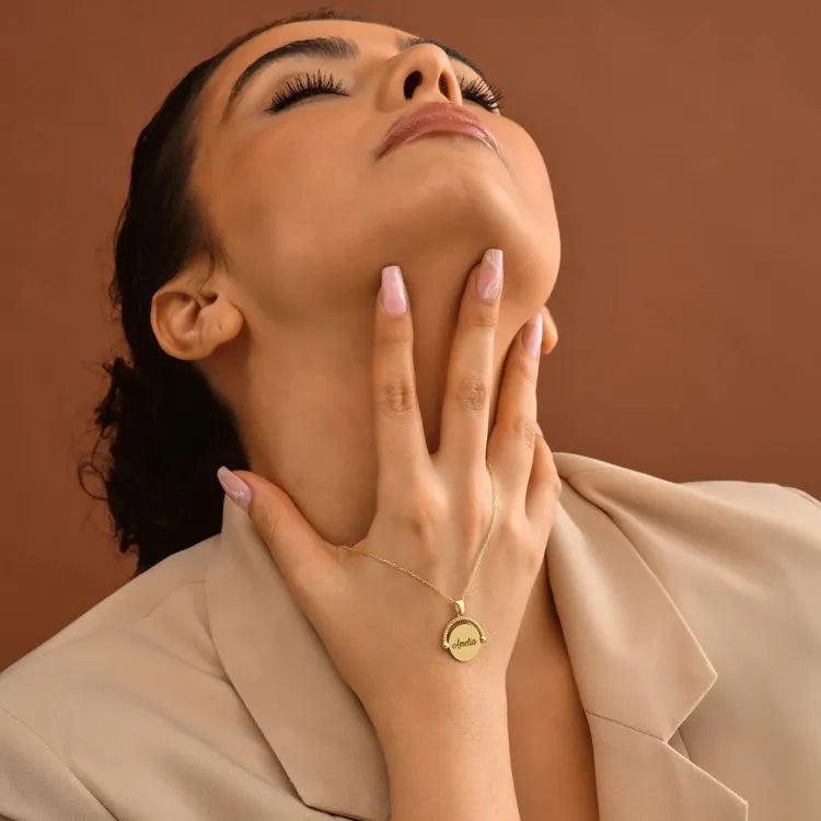 Woman model wearing a 14k gold filled necklace with a pendant against a brown background