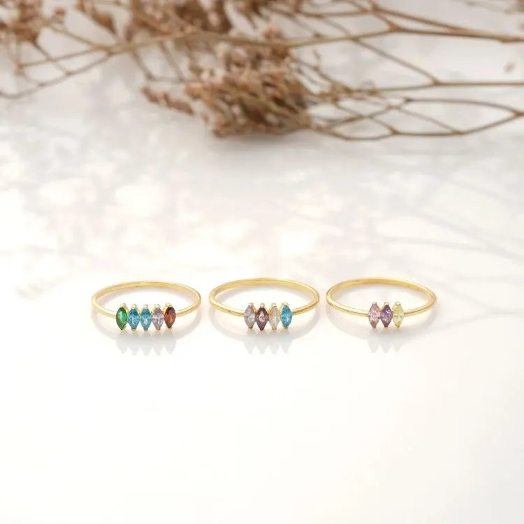 Three marquise birthstone rings with colorful beads on a light background.
Ring materials:
925 sterling siver,
14k gold-filled
14k rose gold-filled