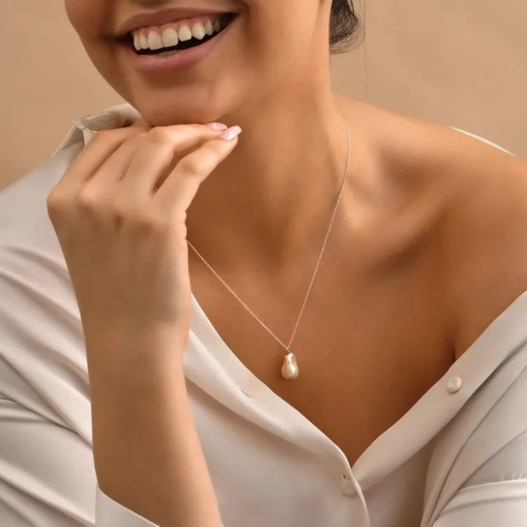 Woman model wearing a pearl necklace with a neutral background