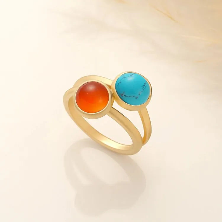 14k Gold filled ring with red carnelian and blue turqouise gemstones on a beige background