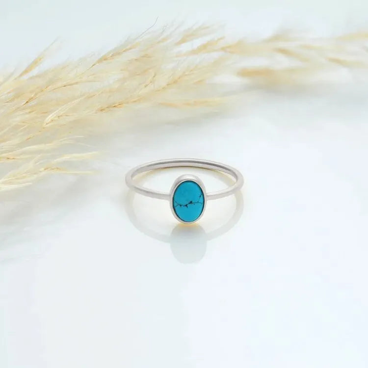 925 sterling silver ring with an oval turquoise stone on a light background