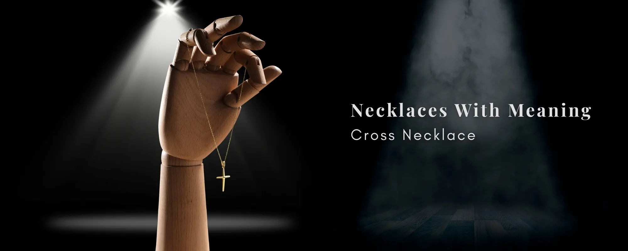 Hand wearing a cross necklace with a spotlight effect on a dark background