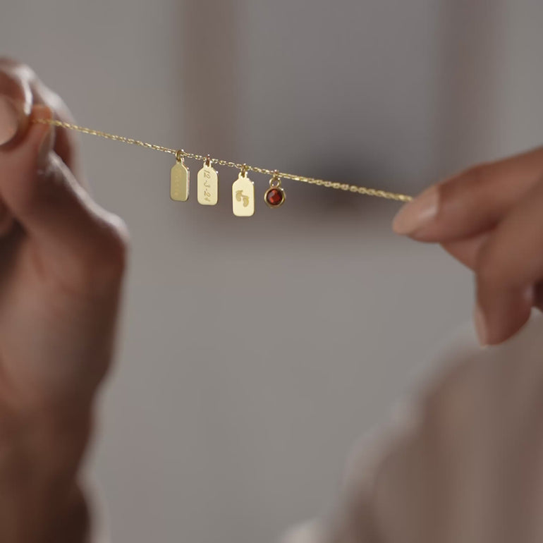 Product video of the personalized name tag necklace with birthstone