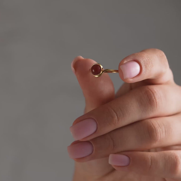 Product and lifestyle video of round natural stone ring.