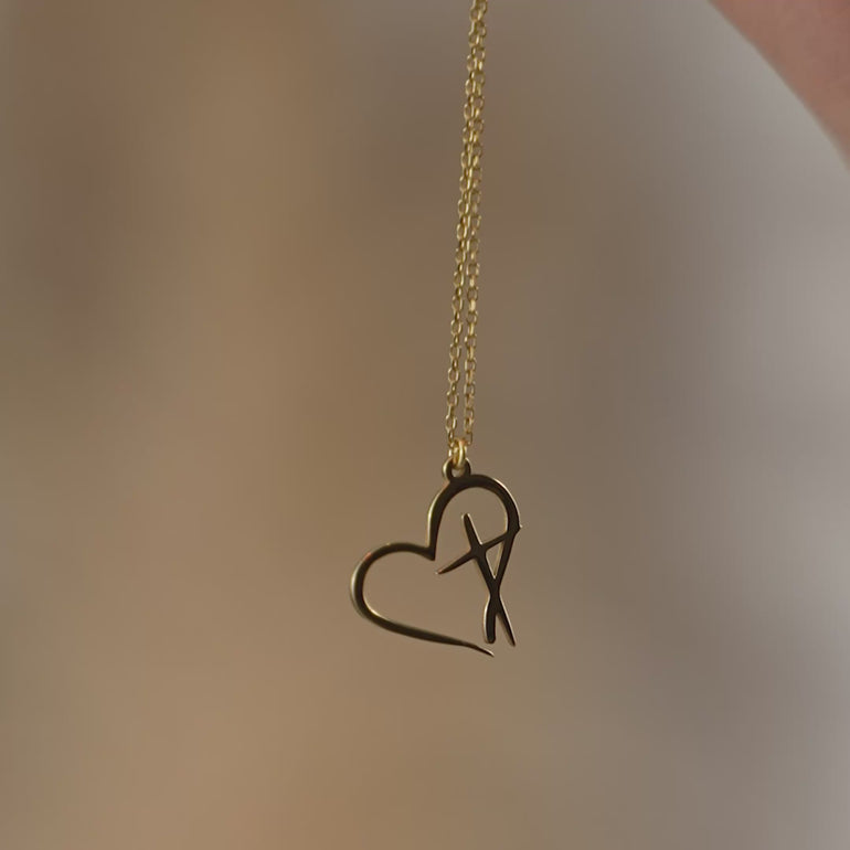 Product video of the minimalist heart cross necklace