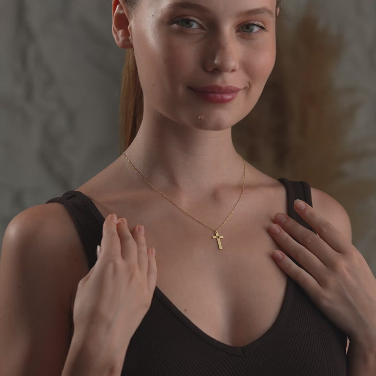 Product video of the custom cross heart cut-out necklace.