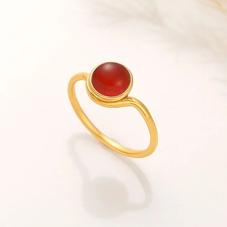 14k Gold filled ring with a round reddish carnelian stone on a white background